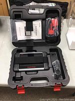 Open case showing scanner, cables and manual fitted in molded slots