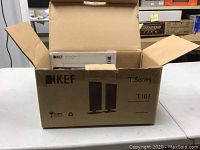 Open KEF branded corrugated box showing T Series T101 printed on exterior, original packaging and foam inserts