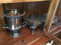 Photo showing silver plated ice bucket and two serving chafing dishes with lids and ornate legs.