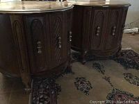 Two matching round wood end tables shown side by side