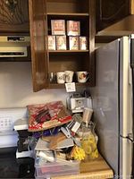 Countertop with assorted cooking utensils and kitchen appliances including coffee maker and food chopper.