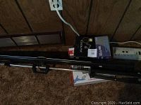 Photo showing adjustable tripod, power bar, camera accessory boxes