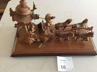 Front angle of the wooden Indian chariot sculpture showing the chariot, horses, and base with some strings visible.