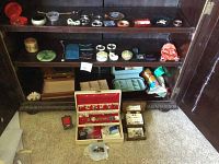 Shelving unit with various costume jewelry and storage boxes