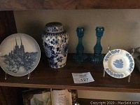 Complete set of blue and white porcelain and blue glass candlesticks arranged on shelf
