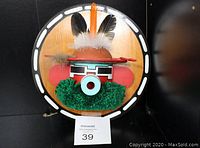 Front view of vintage Hopi Kachina wall plaque mounted on wood, showing colorful feathers, yarn, and painted wood details