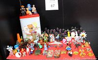 Photo of vintage Teddy Bear tin with over 100 assorted miniature collectible figures and toys displayed in front.