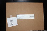 Photo of the plain brown box packaging bearing inventory sticker and product label for The Art of Star Wars Jedi: Fallen Order Limited Edition book.
