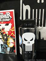 The Punisher War Zone Comic Book #1 (1992) in protective board and bag, next to a sealed 32 oz water bottle with the white Punisher skull logo.