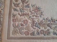 Corner close-up showing floral border and fringe