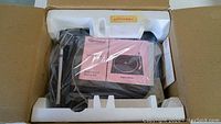 Garrard SP 20B turntable inside original styrofoam packaging, wrapped in plastic, includes instruction manual.