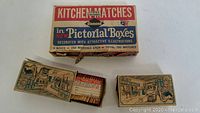 Front view showing three cardboard boxes of vintage Diamond Kitchen Matches with pictorial illustrations, each box contains 250 matches.