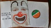 Front of the album cover featuring Charles Mingus in clown makeup holding the LP record with Atlantic JazzImport label visible.