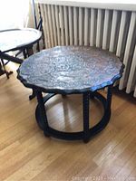 Image showing the full side table with scalloped embossed copper top and black wooden spindle legs.
