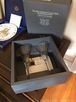 Pair of crystal toasting glasses in original gray packaging box with documentation visible