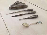 Full view of all 5 vintage sterling silver items arranged on surface