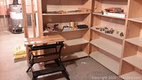 Photo of the Black and Decker Workmate folding workbench in basement setting with shelves in the background, demonstrating workbench condition and size.