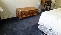 View of cedarwood blanket box in bedroom setting