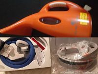 Conair nylon and lint brushes in original box and My Little Steamer handheld fabric steamer wrapped in plastic