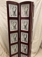 Folding photo room divider with 3 panels, each holding five photo frames with placeholder photo and cherry finish wood