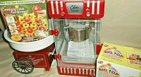 Overview photo showing all items together: Elite popcorn machine, cotton candy machine, Centerpiece Gourmet kit box, and Big Top silicone bake ware boxes.