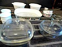17 pieces of mixed ovenware dishes including Fire-King, Anchor Hocking, Corning Ware, and ceramic casseroles and ramekins.