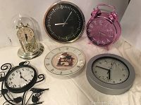 Overview photo of all six clocks showing variety and details of each.