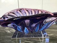 Side angle showing the blue and purple swirl mouthblown glass bowl on acrylic stand.