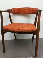 Chair at slight right angle showing side profile and armrest design