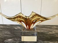 Front view of the Murano glass centrepiece showing its form and amber-clear coloration