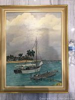 Framed mid-century nautical oil painting signed by Austin Smith featuring a sailboat near pier and shore with palm trees and houses under cloudy sky.