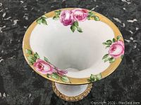 Top view of the vase showing the hand-painted pink roses and gilded rim with some paint loss.