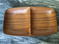Top view photo of the dish showing the divided two-compartment structure and the wood grain pattern.