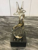 Front view of the Murano blown glass giraffe figurine on black base, showing the clear glass texture and swirl pattern inside.