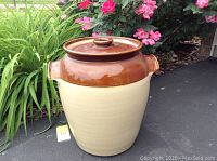 Full view of vintage Pearson's of Chesterfield crock with lid, showing its beige body and brown lid with handles.