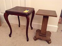 Photo showing the dark wood square table with Queen Anne legs alongside the lighter wood plant stand on carpeted floor.