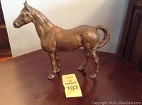 Side view of cast iron horse figurine showing details and overall shape