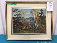 Full front view of framed painting showing gold-tone frame, linen mat, and landscape scene