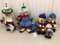 Front view of all five crochet dolls including golfing couple and Scottish family dolls showing details and color