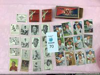 Overall view of 32 trading cards, two gum packs and matchbox