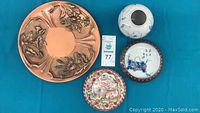 Top view of all 4 assorted plates and bowls on blue surface showing different patterns and colors