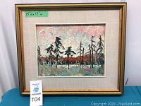 Front view of framed painting with gold frame and linen mat showing impasto spruce landscape