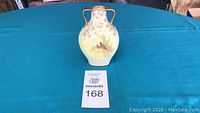 Front view of vintage Doulton Burslem vase with pheasant decoration and auction lot card 168