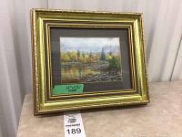 Full view of the framed watercolor painting "Little Isle Pool, R. Ness" by Gordon A. Rennie showing gold frame and wall background.