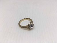 Gold-tone Swarovski Angelic ring with clear crystal cluster center on white background showing side angle.