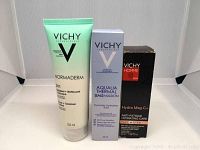Three VICHY skincare products: Normaderm cleanser tube, Aqualia Thermal hydration fluid box, Homme Hydra Mag C+ anti-fatigue care box