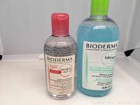 Two Bioderma micellar waters: Sensibio H2O AR with a red cap and Sébium H2O with a green cap.