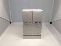 Four boxed RéVive Broad Spectrum SPF 50 Sunscreen products, front view, white background.