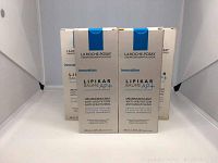 Five La Roche-Posay Lipikar Baume AP+ balm boxes shown closely to display packaging and branding.