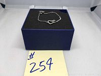 Swarovski bracelet placed on black foam inside a blue box shown from a distance.